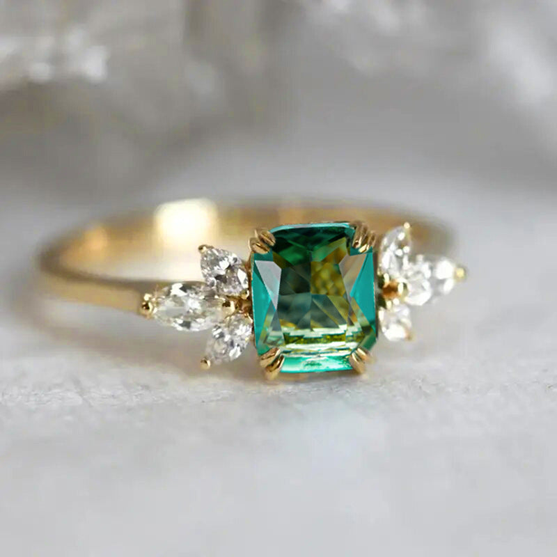 Rectangular‑Cut Simulated Emerald Ring With Side Accent Stones