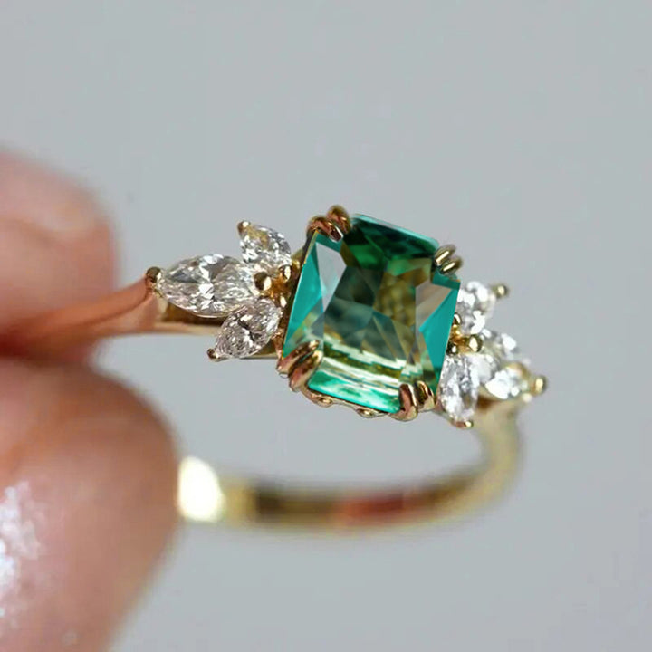 Rectangular‑Cut Simulated Emerald Ring With Side Accent Stones