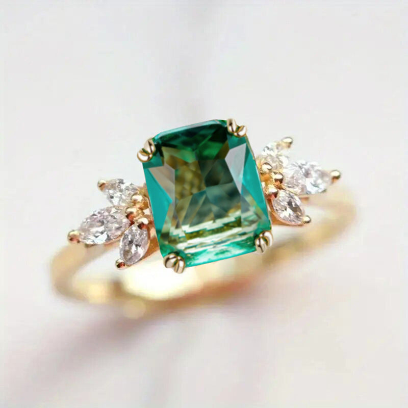 Rectangular‑Cut Simulated Emerald Ring With Side Accent Stones