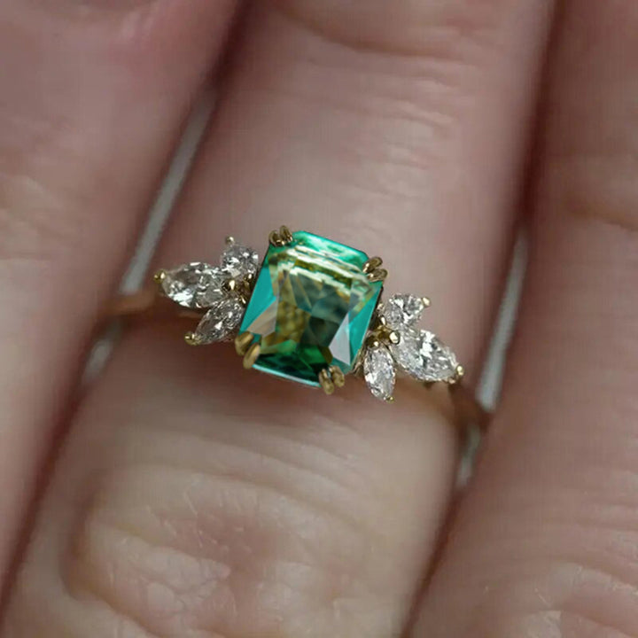 Rectangular‑Cut Simulated Emerald Ring With Side Accent Stones