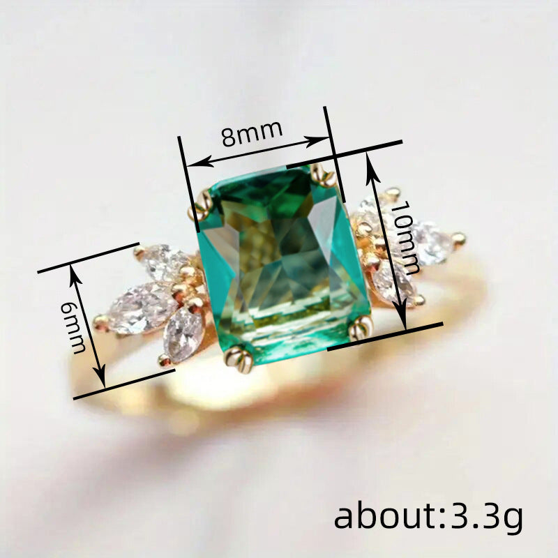Rectangular‑Cut Simulated Emerald Ring With Side Accent Stones
